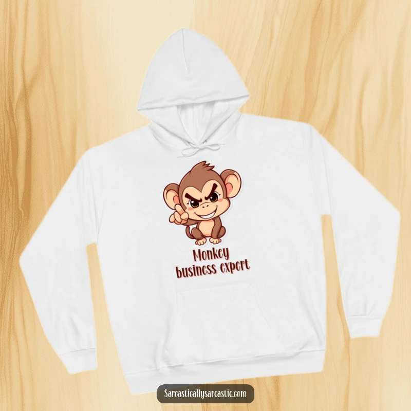 Funny Hoodie: Mischievous monkey in a cozy hoodie, grinning and pointing accusingly, embodying hilarious playfulness.