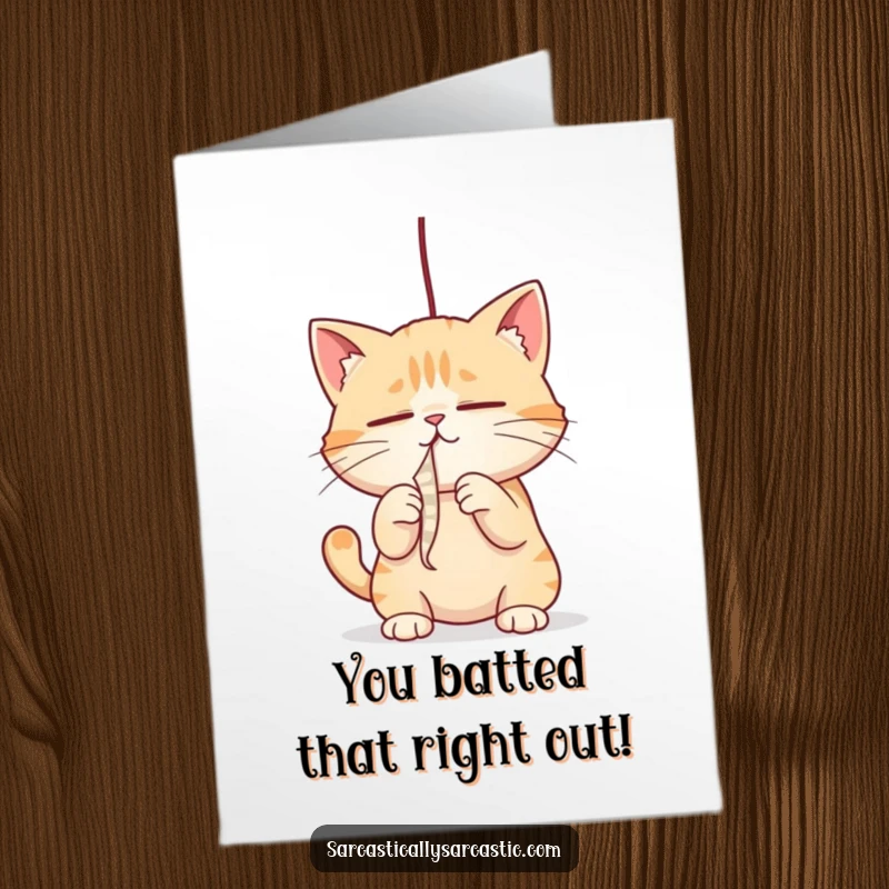 Free Printable Congratulations Card: A cat fixes its narrowed gaze on a string, playfully batting it in a moment of focused success.